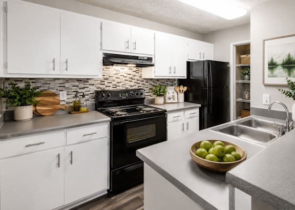 A dining room with a table set for four at Southland Station Apartments, Warner Robins, GA