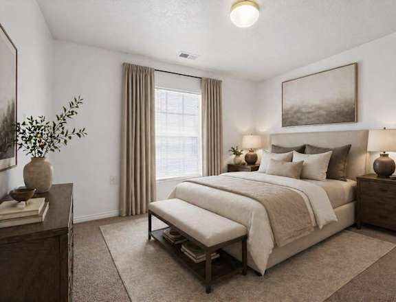 A bedroom with a large bed and a painting on the wall.