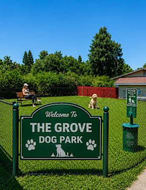 A sign welcoming visitors to The Grove Dog Park.