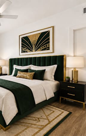 A bedroom with a large bed and a ceiling fan.