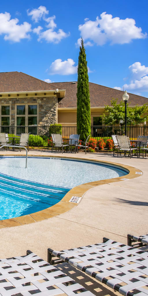 A large swimming pool with a sign that says "NO DIVING" in front of a house.