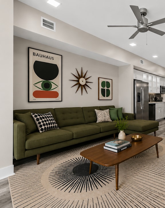 A living room with a green couch and a coffee table.