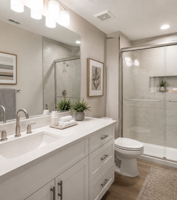 A bathroom with a white sink and toilet.