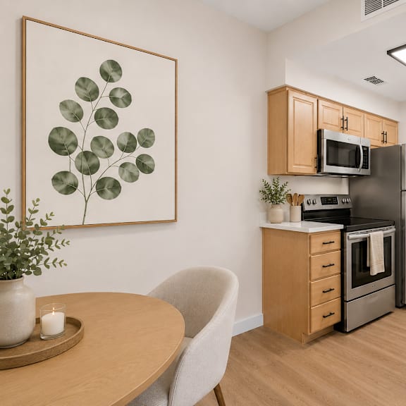 A living room with a couch, chair, and a table with a plant on it.