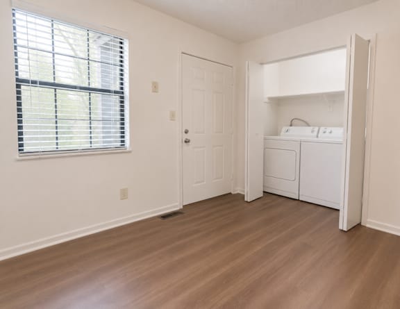 A bedroom with a bed, dresser, and lamp at Sandstone Court Apartments, Greenwood, IN.