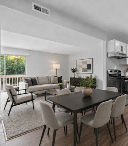 A modern kitchen with a dining table and chairs.