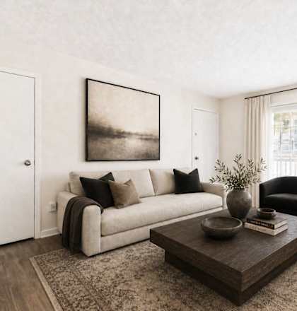 A living room with a couch, chair, and coffee table.