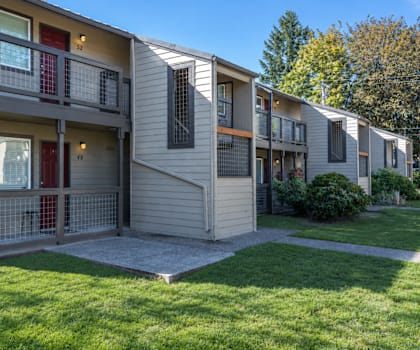 Apartment building with a green lawn in front.