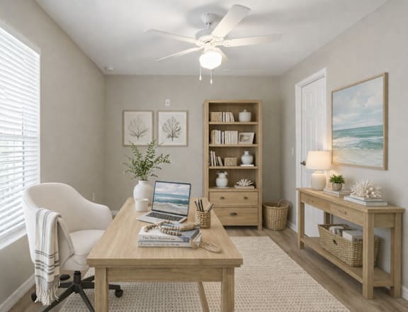 A room with a desk, chair, and a bookshelf.