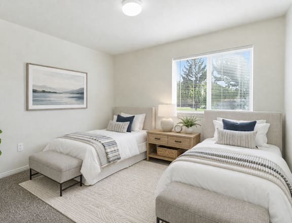 A bedroom with two beds, a nightstand, and a plant. at Diamond Fork Apartments, Utah, 84660