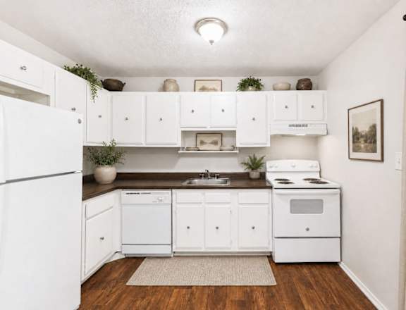 A small kitchen with white appliances and cabinets.