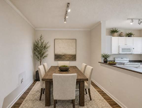 A dining room with a wooden table and chairs.