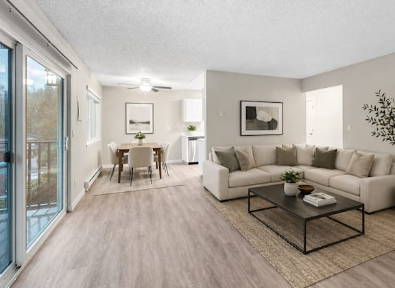 A living room with a white couch and a coffee table.