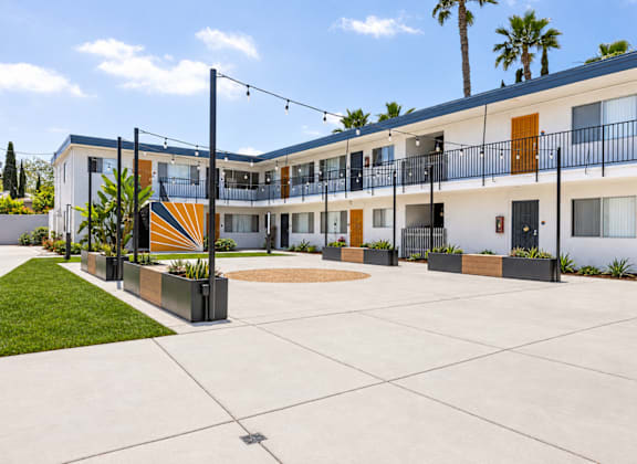 A sunny day at a modern apartment complex with a courtyard.