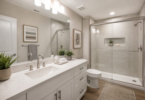 A bathroom with a white sink and toilet.