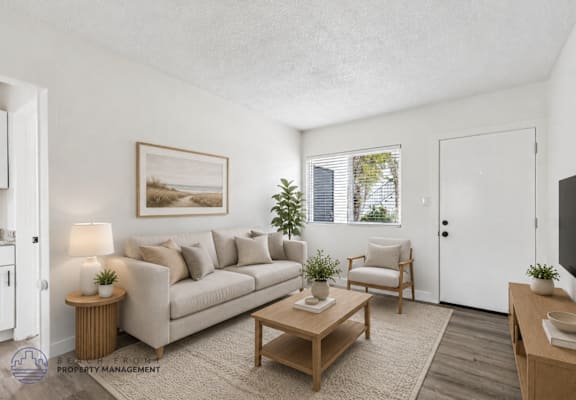A living room with a couch, chair, and table.