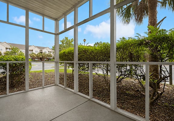 A sunny day in a patio with a view of the street.