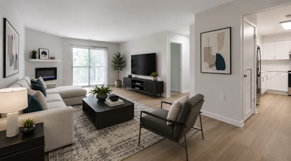 A modern living room with a white couch, a black chair, and a coffee table.