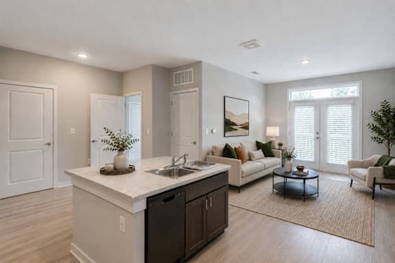 Professionally staged open-concept living room at Townes at Clarkston Centre, a pet-friendly apartment community in Clarkston, GA near Decatur.