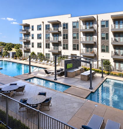 A large apartment complex with a pool.