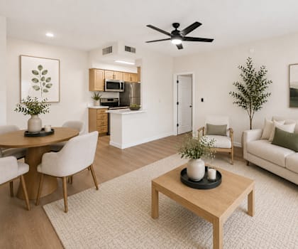 A living room with a couch, coffee table, and a dining table.