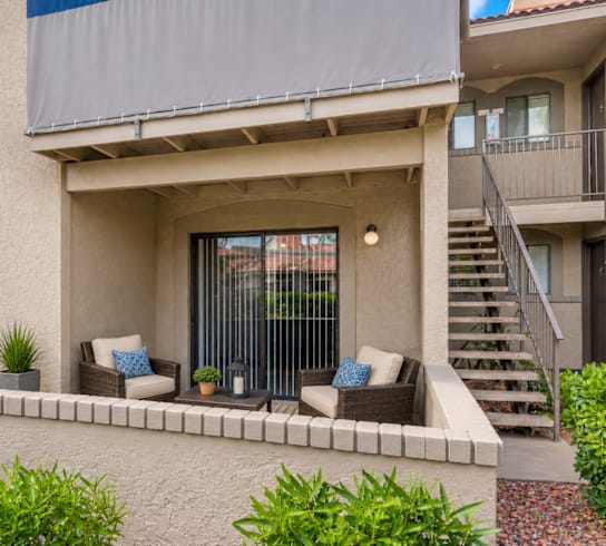 A modern house with a patio and a staircase.