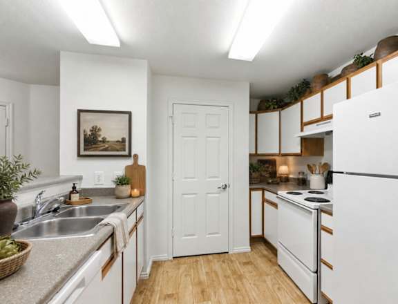 A kitchen with white appliances and wooden floors. at Slate Canyon Apartments, Utah, 84606