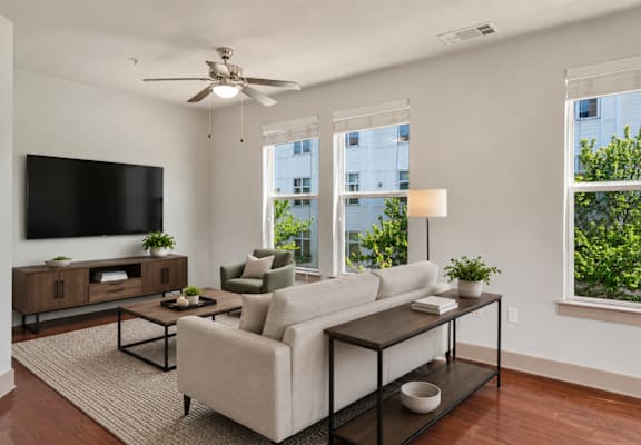 A living room with a couch, chair, and television.