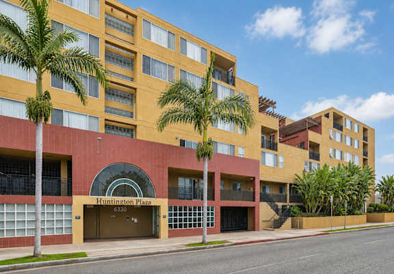Huntington Plaza is a multi-story building with a red and yellow facade.