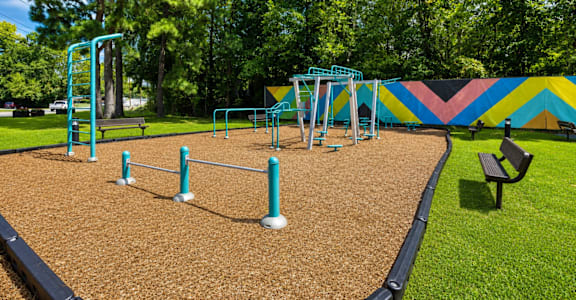 A playground with a slide, swings, and a climbing frame.