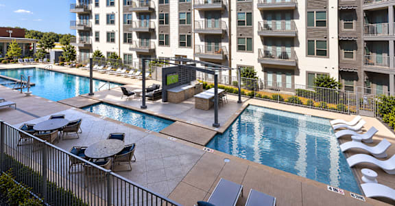 A large apartment complex with a pool.