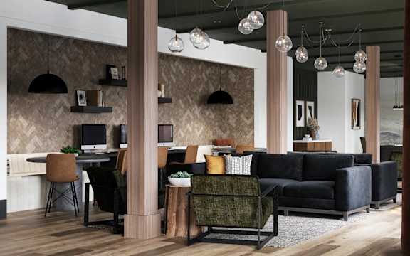 A modern living room with a black couch and a wooden floor at The SoHo Luxury Apartments, Raleigh, North Carolina