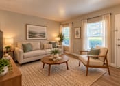 Thumbnail 7 of 11 - A living room with a couch, chair, and a painting on the wall at Lifestyle at Shreveport in Shreveport, LA, 71109.