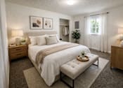Thumbnail 5 of 8 - A bedroom with a large bed and a bench in front of it.