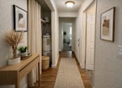 Thumbnail 6 of 8 - A hallway with a light brown bench and a beige rug.