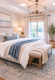 A bedroom with a large bed and a chandelier.