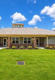 A house with a well-maintained lawn in front.