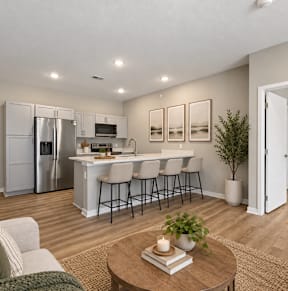 A white bathroom with wooden floors and a white toilet at Siena Crossing Apartments, Ankeny, IA, 50223