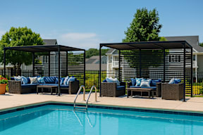 A pool with a slide and a black canopy.
