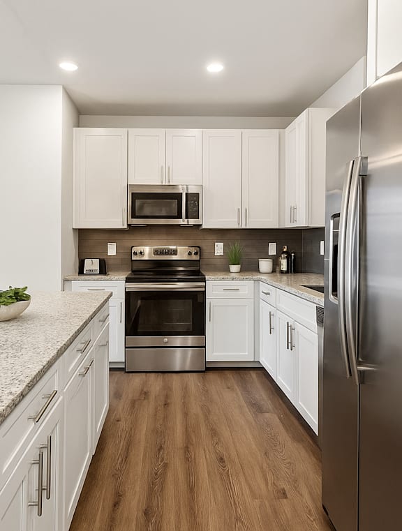 A modern kitchen with a refrigerator on the right.
