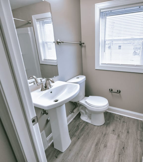 A white sink and toilet in a small bathroom.