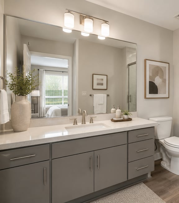 A modern bathroom with a white toilet and a walk-in shower.