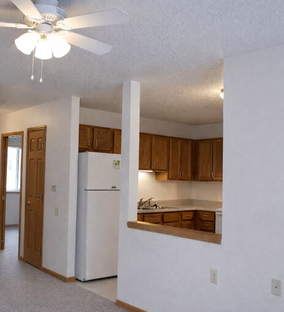 a living room and kitchen with a couch and a table