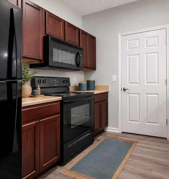 A kitchen with black appliances and wooden cabinets.