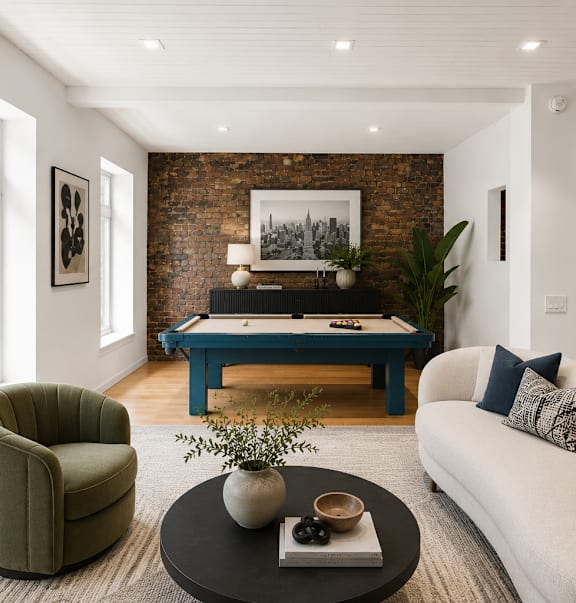 A living room with a white couch, a green armchair, and a blue coffee table.