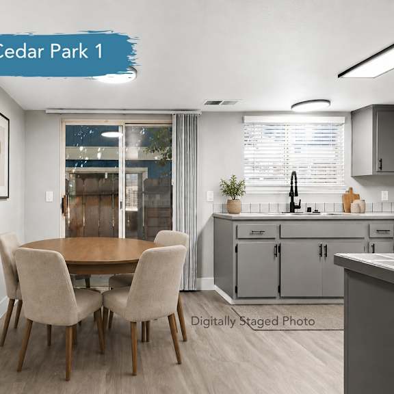 A kitchen with a white refrigerator, white oven, and grey cabinets.at Cedar Park Apartments, Chico, CA, 95926
