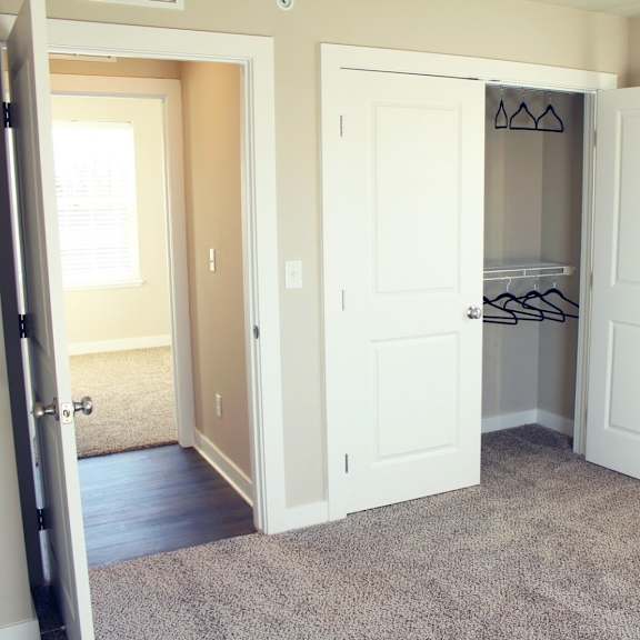 A kitchen with a stove, sink, and cabinets.