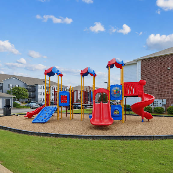 playground at Lancaster Place Apartments in Calera, AL with colorful play equipment and outdoor recreation for families.