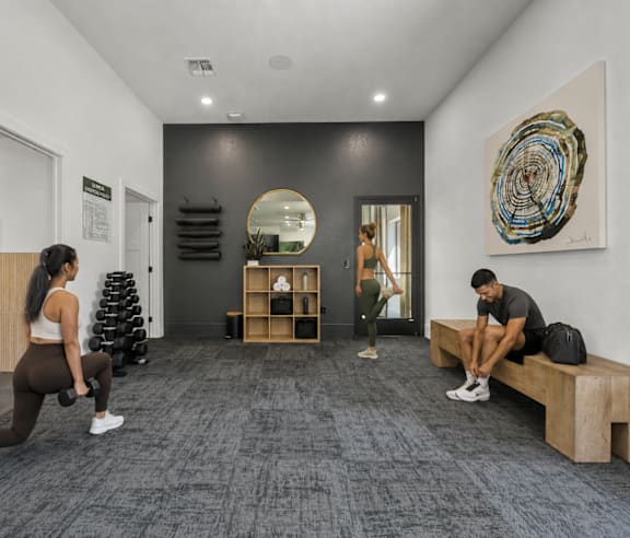 A spacious gym with a variety of equipment including treadmills, elliptical machines, and weights.