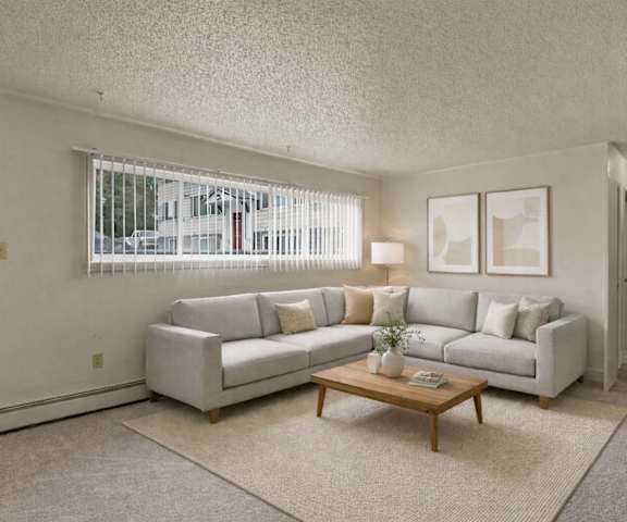 An empty carpeted bedroom with a window at Montclair Apartment Homes. 